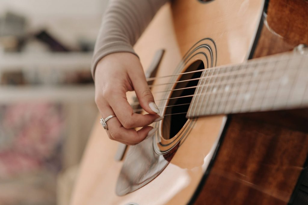 Close-Up Shot of a Person Playing Guitar