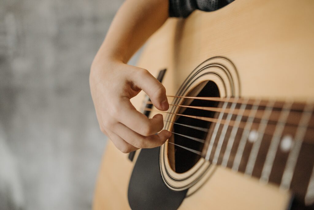 kid playing acoustic guitar